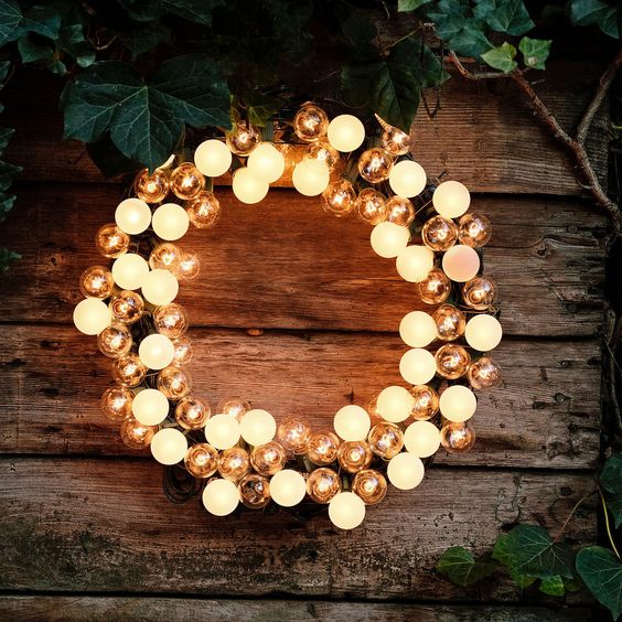 A lightweight Christmas wreath with clear and matte light bulbs is a cool and eye-catching decoration for the holidays