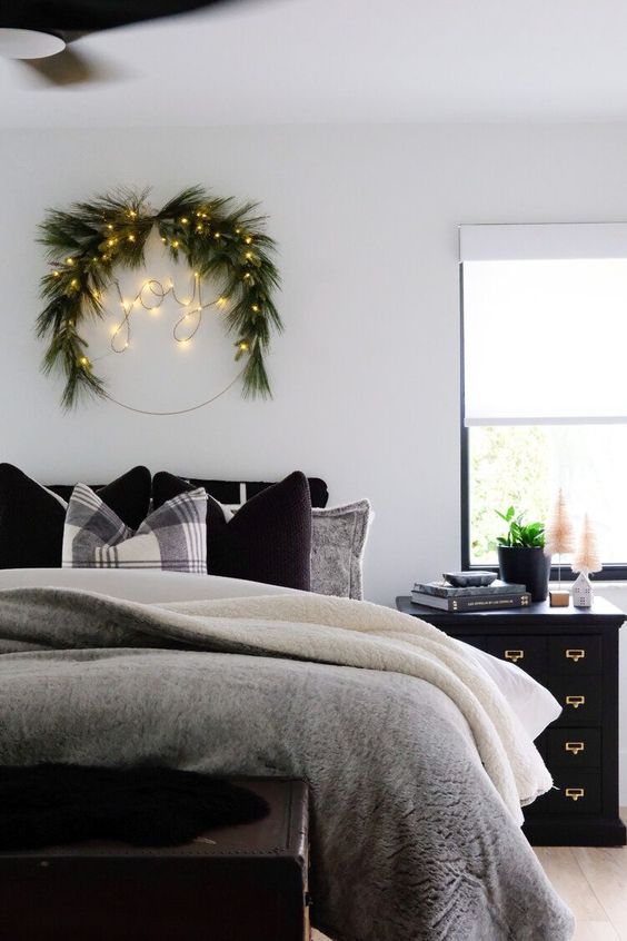 A Scandinavian Christmas wreath made with evergreens and lights that form a word is a cool decoration idea