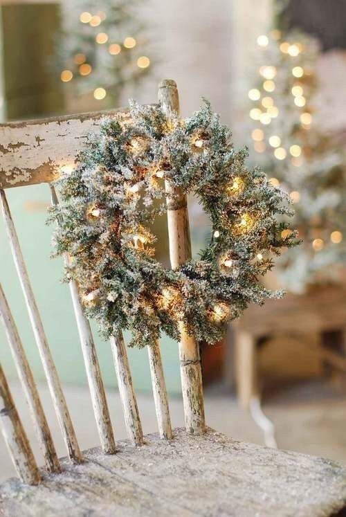 A small flocked Christmas wreath decorated with lights is a cool decoration idea for the holidays