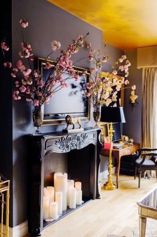 a large, sophisticated black fireplace with large pillar candles that provide a stark contrast to the fireplace itself