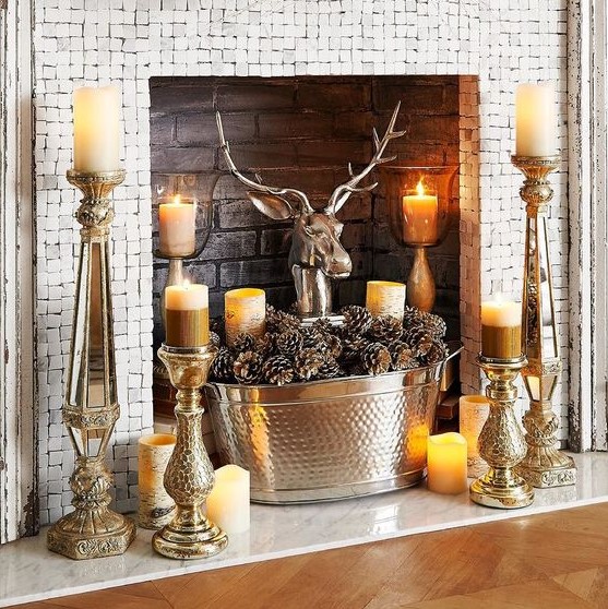 Bold rustic style with candles on vintage candle holders, a tub of pine cones and a fake deer head