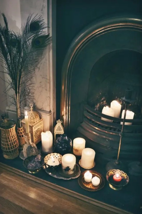A few candles in the fireplace and on small trays and plates next to it create a boho feel