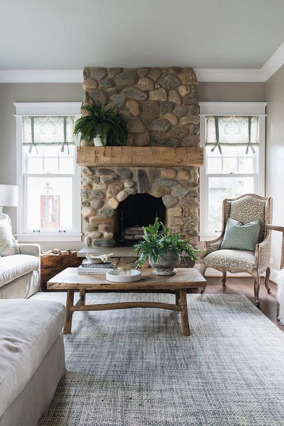 a sophisticated vintage living room with a river fireplace that adds a touch of nature to the room