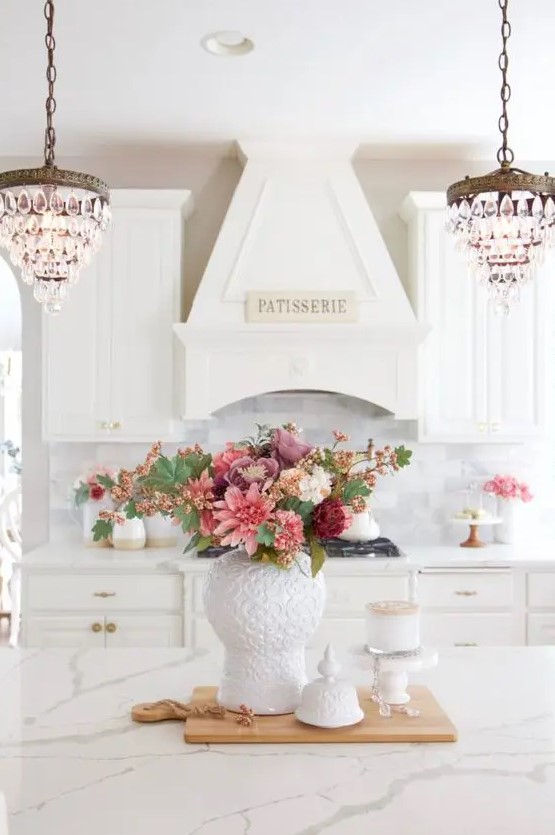 a chic, monochromatic floral centerpiece of pink, dusty rose, burgundy and white flowers and greenery for fall