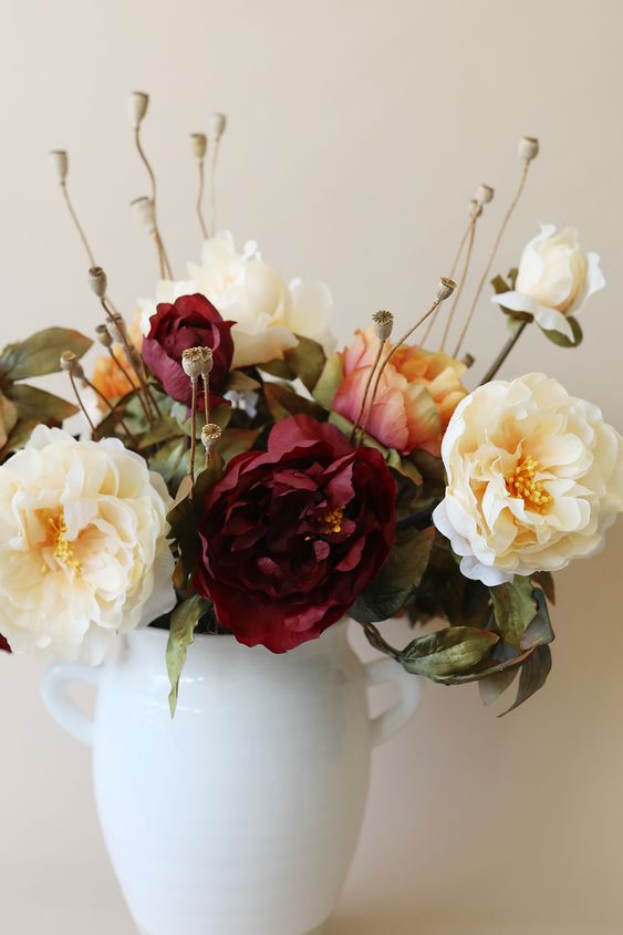 A simple artificial fall flower arrangement in neutral tones and burgundy is a beautiful idea, it will add elegance to the room