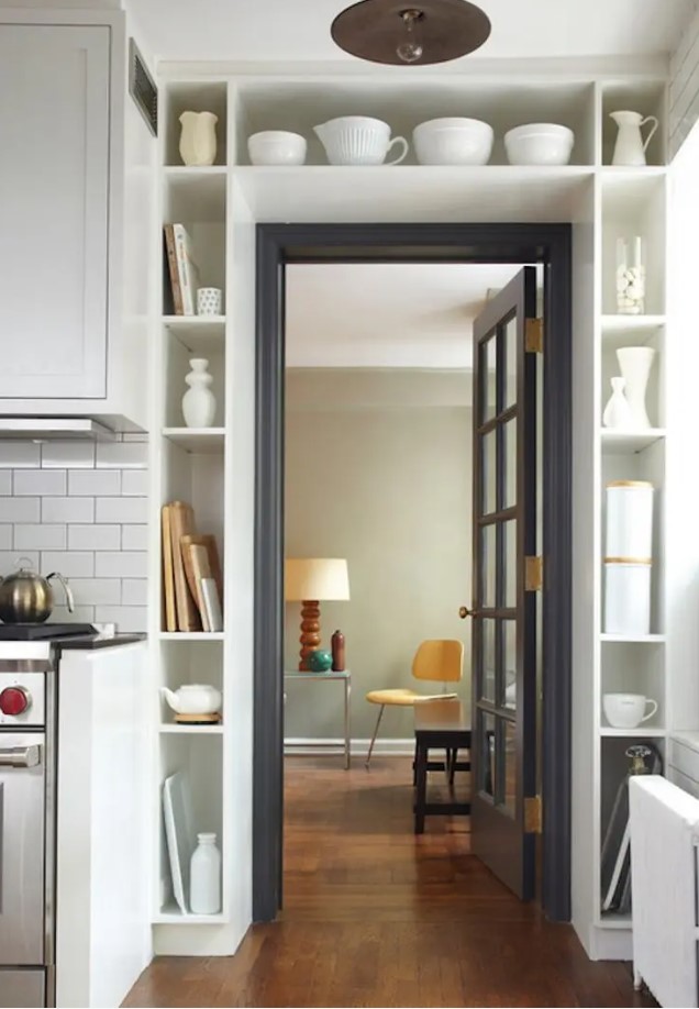 A doorway area occupied by open shelves displaying pretty dishes and cookware as well as some cutting boards is a lovely idea for any kitchen or dining room