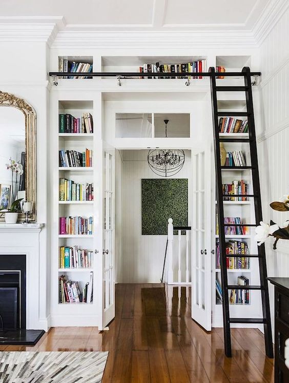 A door surrounded by open shelves for storing books is a great idea for saving space
