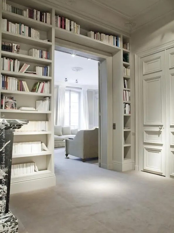 A door with built-in open shelves on either side and above the door is a smart idea for storing books rather than putting a boring bookshelf somewhere
