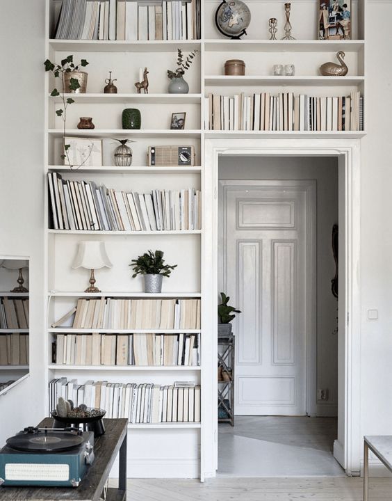 A door with built-in bookshelves with books and other things is a nice idea for any home. Make use of this unused space