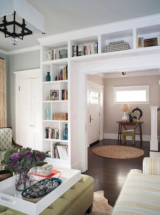 A door with built-in shelves is a cool idea for storing books and various decorations, displaying them to their best advantage without sacrificing floor space