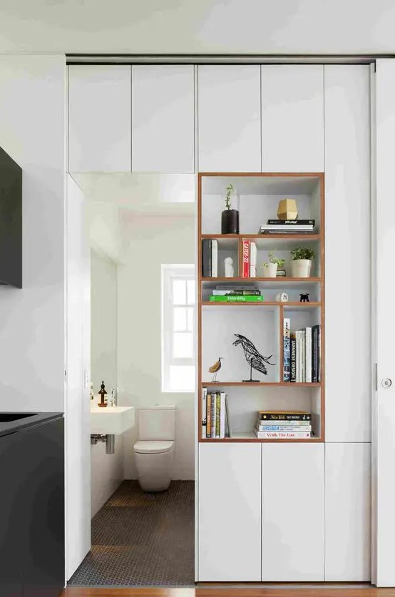 A door with open shelves and elegant cabinets right in the door is a cool idea to separate a small bathroom from another room