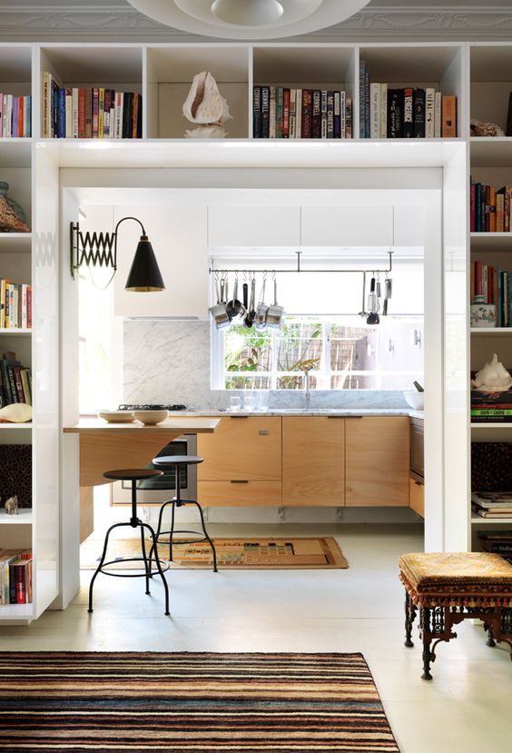 A modern room with a door and open storage shelves used for display and storage