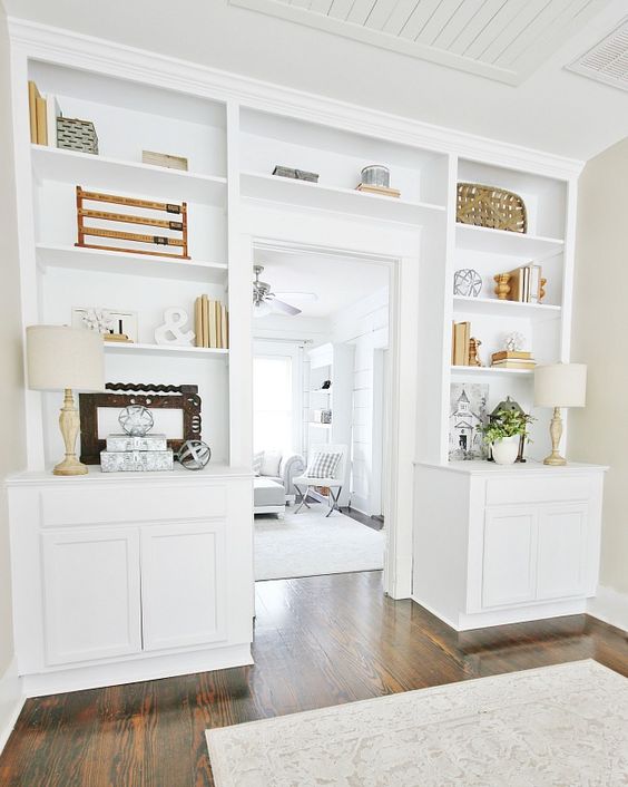 A white modern farmhouse storage cabinet with an over the door shelf to create more display space