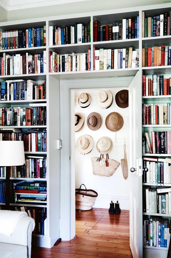 If you have a lot of books at home, an entire wall taken up with bookshelves, including the space above the door, is a smart solution