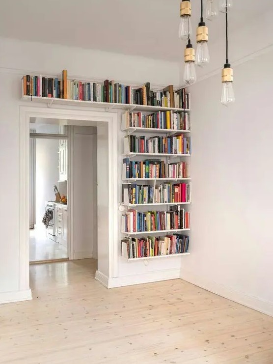 Bookshelves that cover a wall next to the door and a space above give you plenty of space for books and help you declutter the room