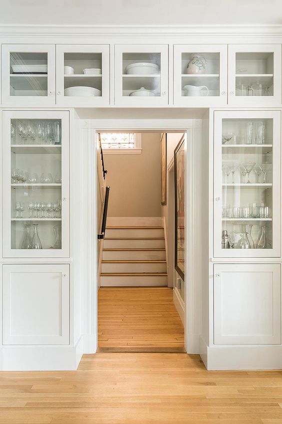 It's amazing to have the cream colored storage units that completely surround the door and provide space for glassware and china