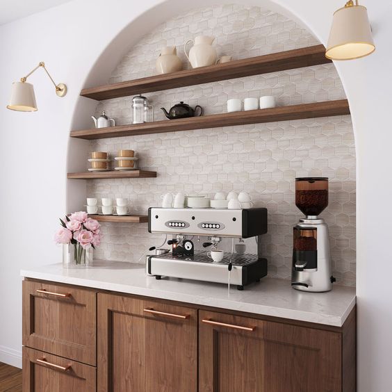 an arched niche clad with hex tiles, with open stained shelves and a cabinet is a lovely home coffee and tea bar that looks awesome