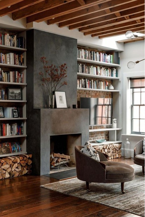 a cozy warm-colored living room with wooden beams, built-in shelves, a fireplace clad with metal and round chairs