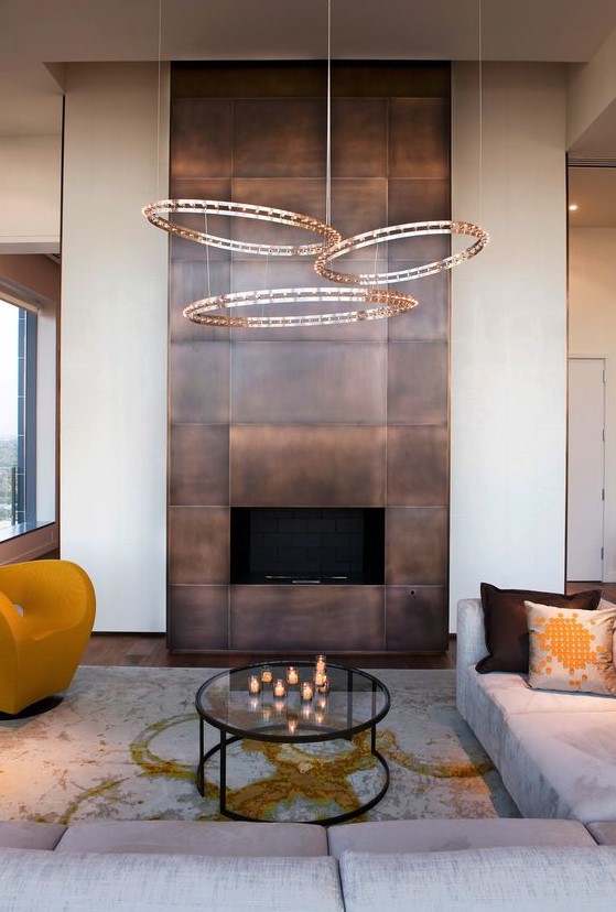 a modern fireplace clad with darkened copper looks really wow and impressive and will make a statement in the space