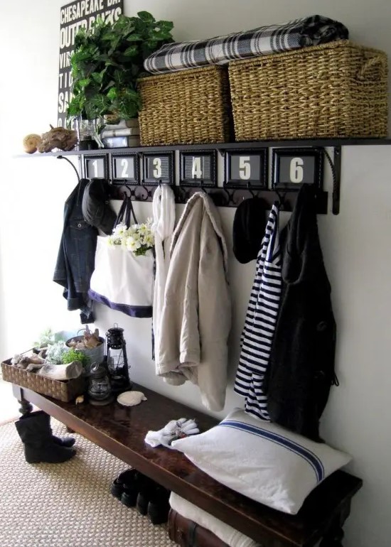 a modern rustic entryway with a dark vintage bench, a rack with basket boxes and a jute rug