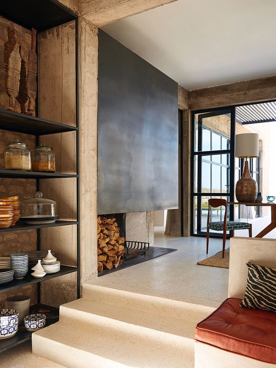 a neutral modern country space with a fireplace done with metal over it is very welcoming and cool
