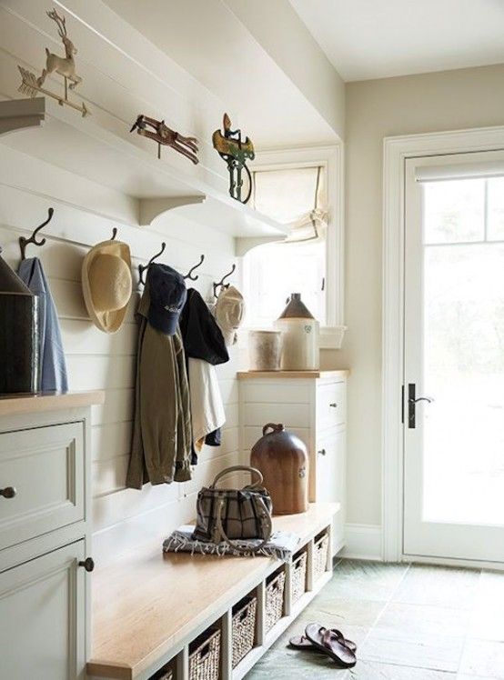 a neutral modern farmhouse entryway with shiplap walls, white dressers and a built-in bench, a racj and some shelves