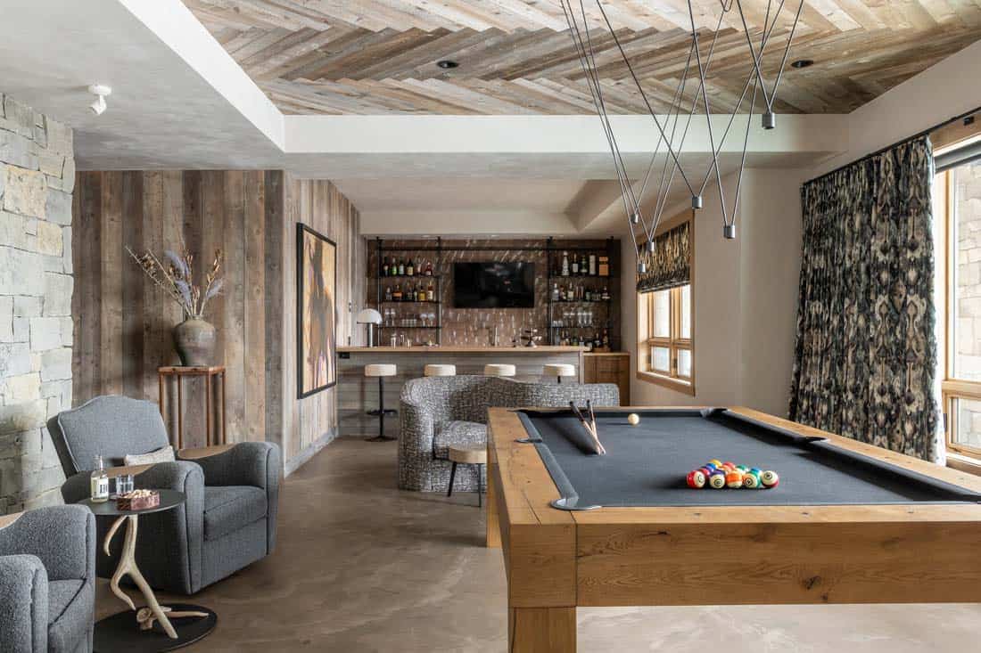 Modern, rustic family room with bar and pool table