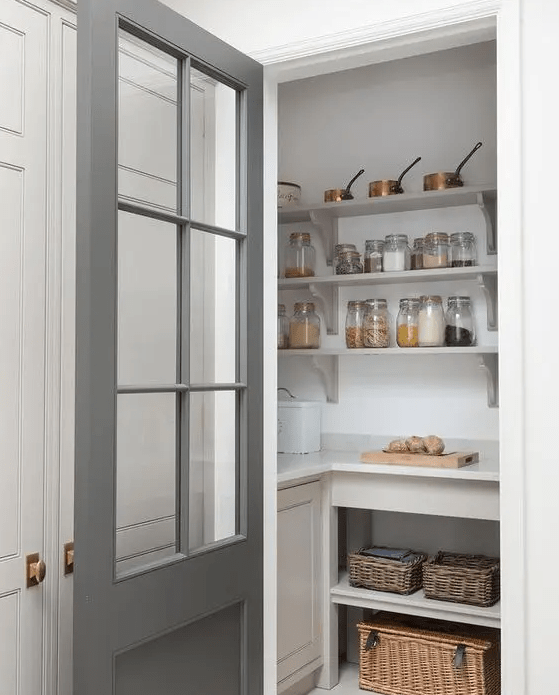 A small pantry with open shelves, built-in storage units, baskets, various foods and cookware is a cool solution