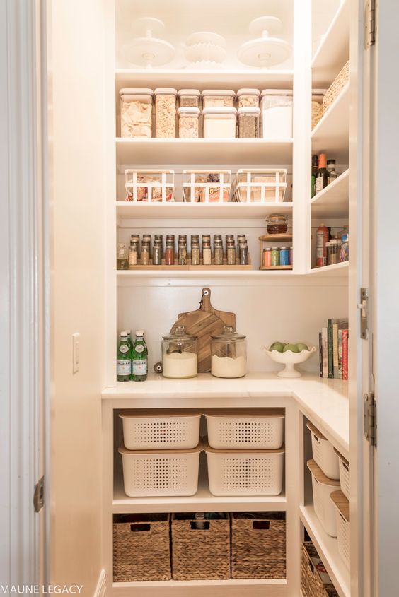 A small, well-organized pantry with lights, open shelves, cubbies, and baskets makes a cool storage spot