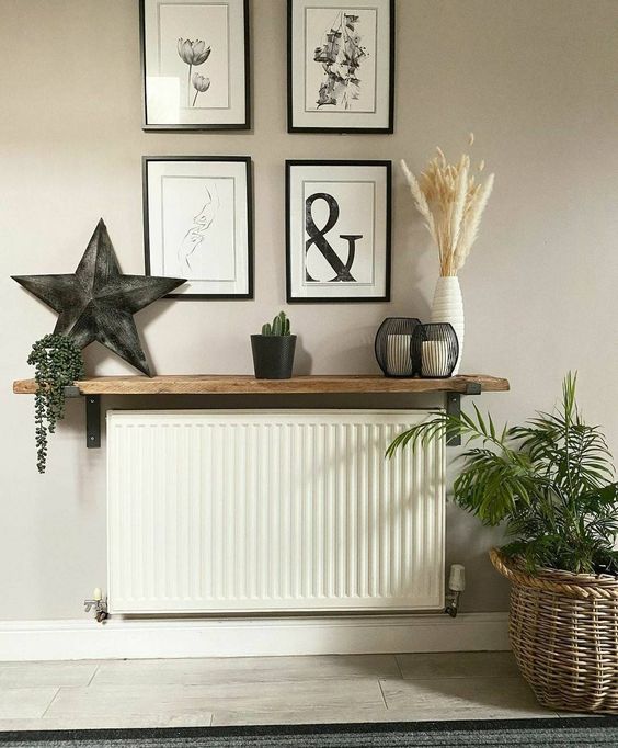 A small shelf above the radiator becomes a cool console table for a small entrance area and looks very harmonious