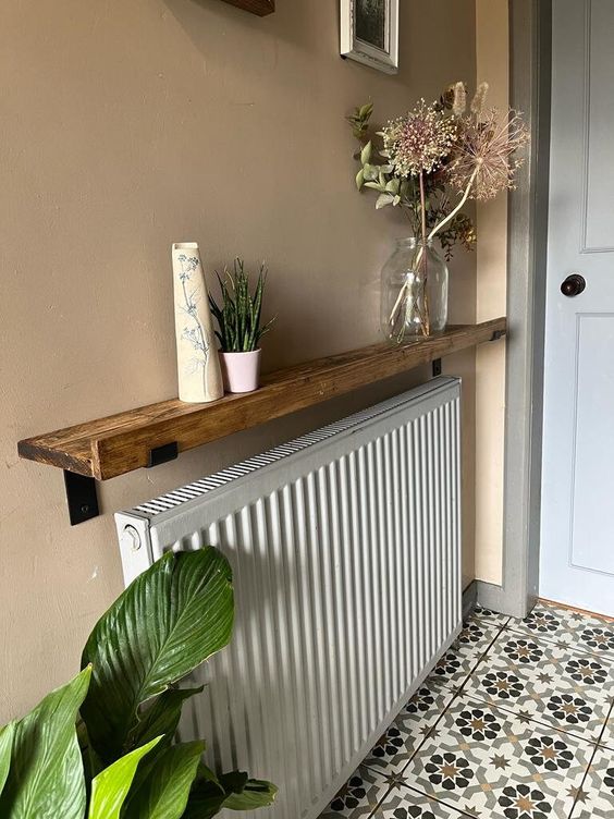 A radiator covered in stained trim to display decorations is a cool idea for any modern home