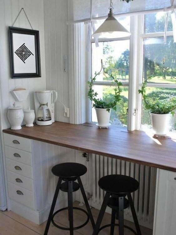 A radiator with a stained shelf and cupboards on either side serves as a breakfast book with a beautiful view