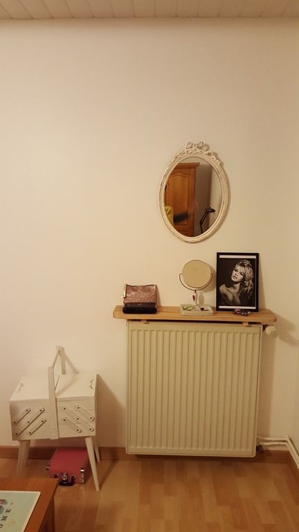 A small radiator with a shelf and some decor is a cool idea for any room