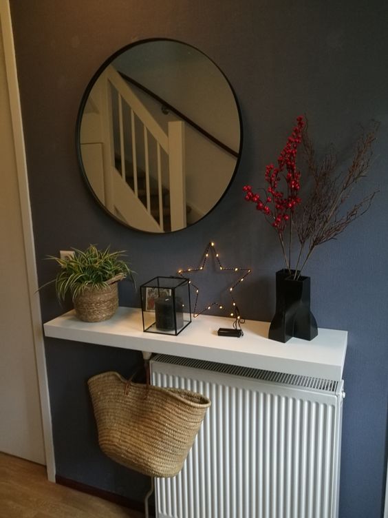 A white radiator with a white shelf and stylish Scandinavian decor is fantastic
