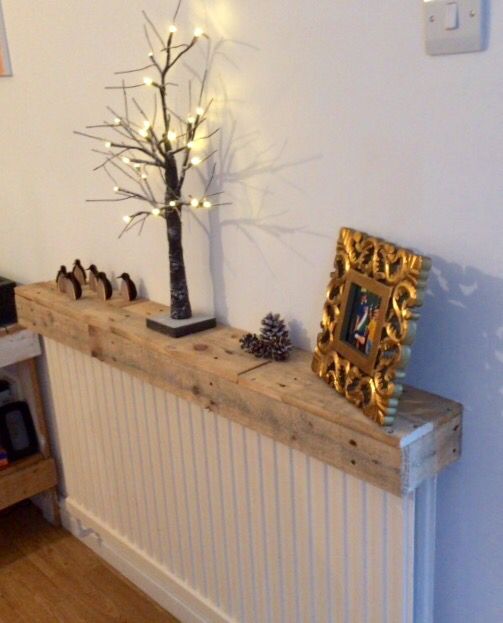 A pallet radiator shelf used to display things is a great way to upgrade an old pallet or other old piece of wood