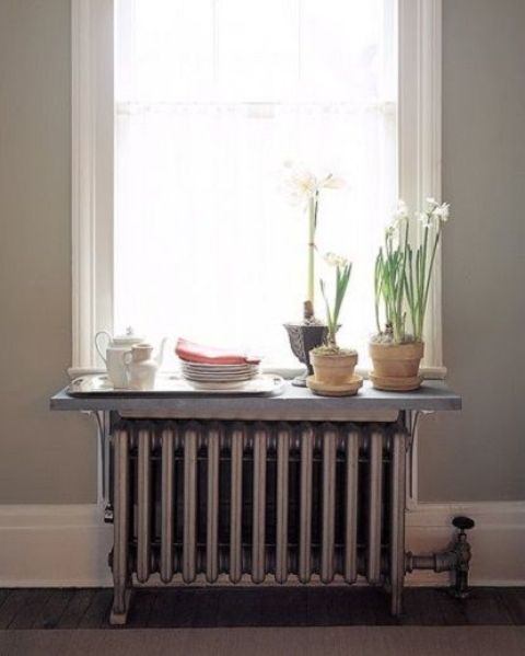 A shelf placed on the radiator and used as a windowsill is a small but helpful storage unit you can make yourself