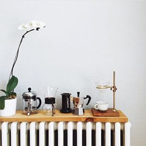 A wooden shelf on the radiator, used for tea supplies in the kitchen, is a nice additional shelf for any room