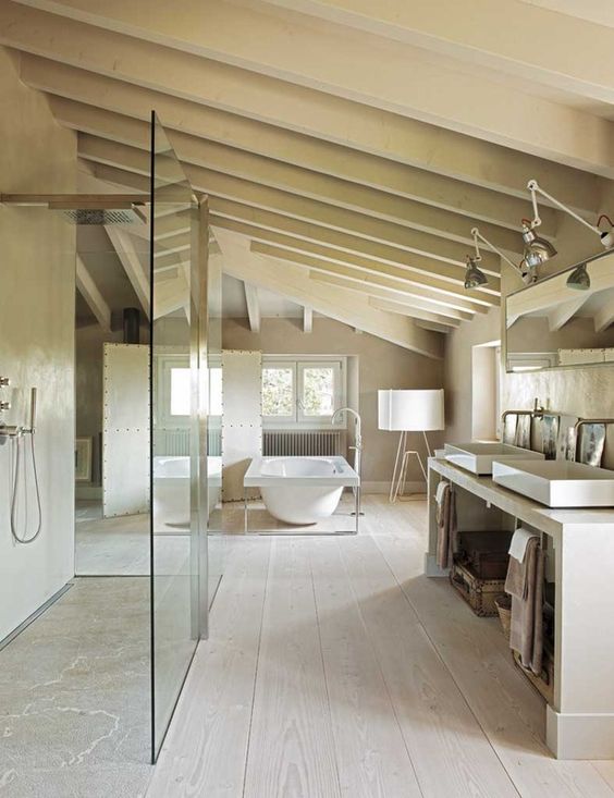 a neutral, modern bathroom with a shower and bathtub, a double vanity, wooden beams and vintage fixtures and lamps
