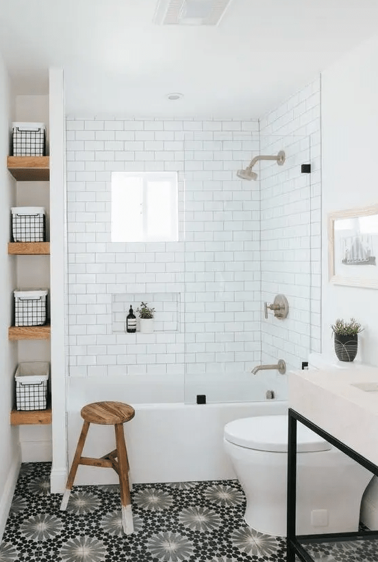 a modern bathroom with a white background and black printed tiles, a vanity unit with a sink, a niche with shelves and a stool
