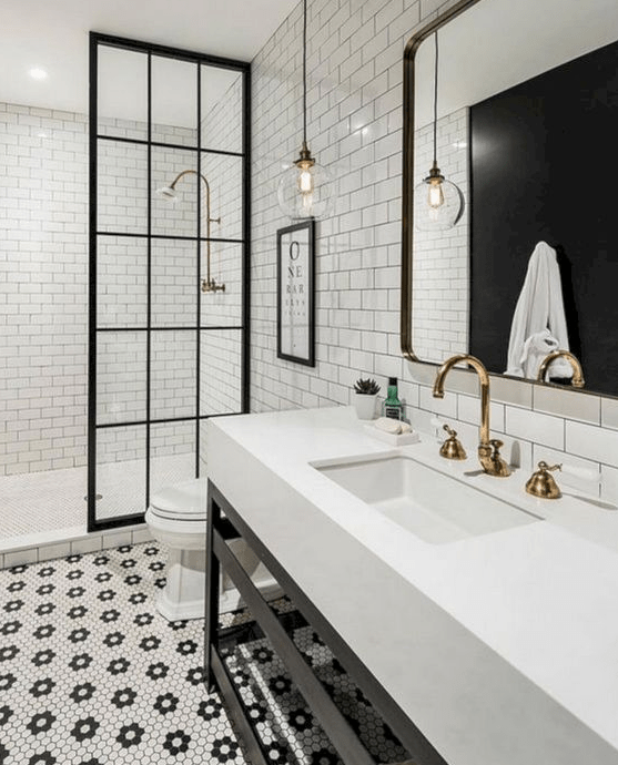 Hex penny tiles with floral patterns on the floor and neutral white subway tiles with black grout on the walls
