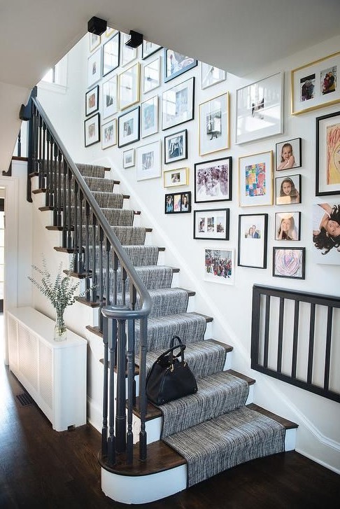 A freeform gallery wall with different frames and eye-catching black and white artwork and family photos is a cool idea