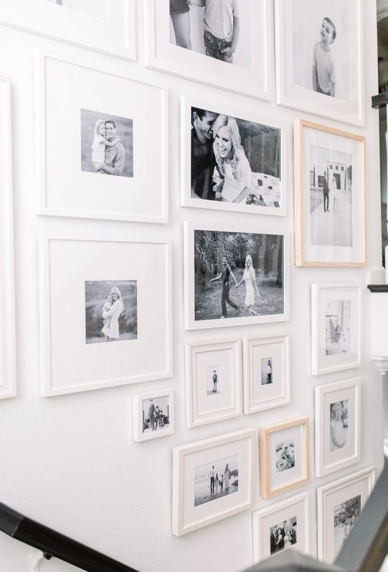 A free-form gallery wall with mismatched frames and black and white photos is a stylish and chic idea with an eclectic touch