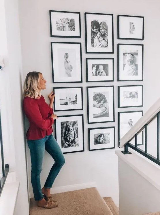 A stylish gallery wall with black and white family pictures in matching black frames is fantastic and looks perfect