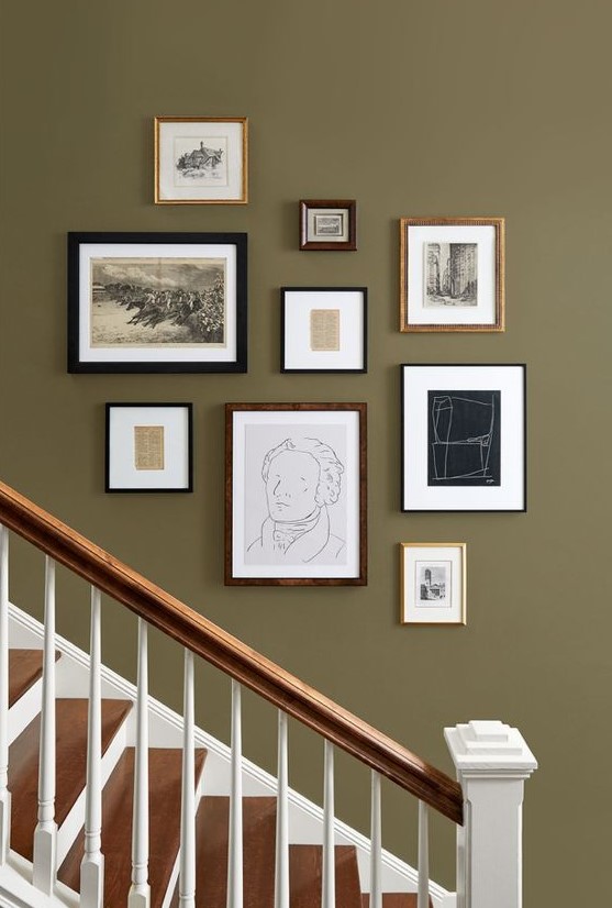 A vintage gallery wall with mismatched frames and artwork, black and white for a stylish look