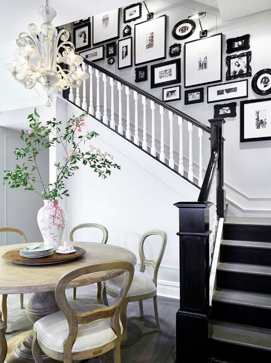 A vintage gallery wall with mismatched, sophisticated and modern black frames gives the room an elegant and chic atmosphere