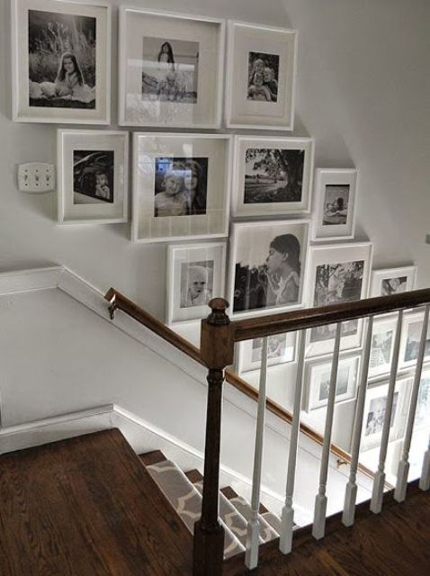 A family gallery wall in black and white with white frames to make it look light and airy on the wall