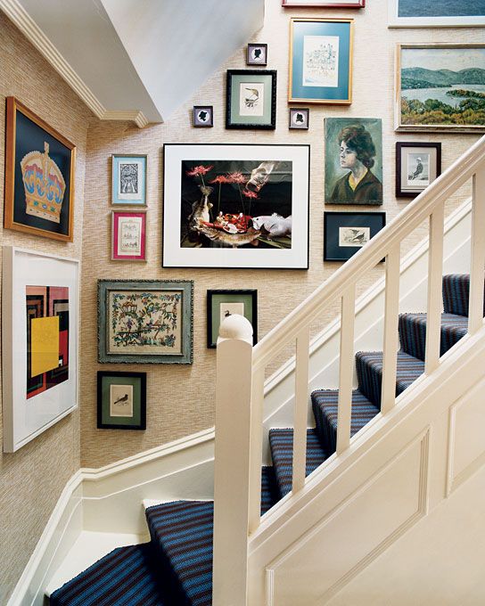 a bright gallery wall that takes up several walls, with colorful and black and white artwork and photos and mismatched frames