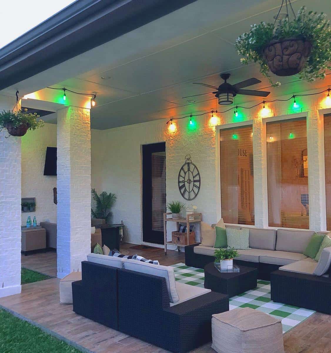 Terrace with colorful fairy lights and wicker furniture 