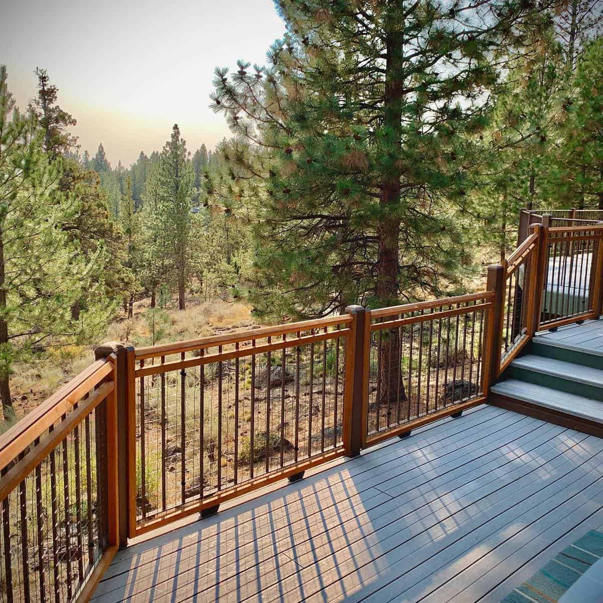 two-tone tan and gray deck and railings with forest views 