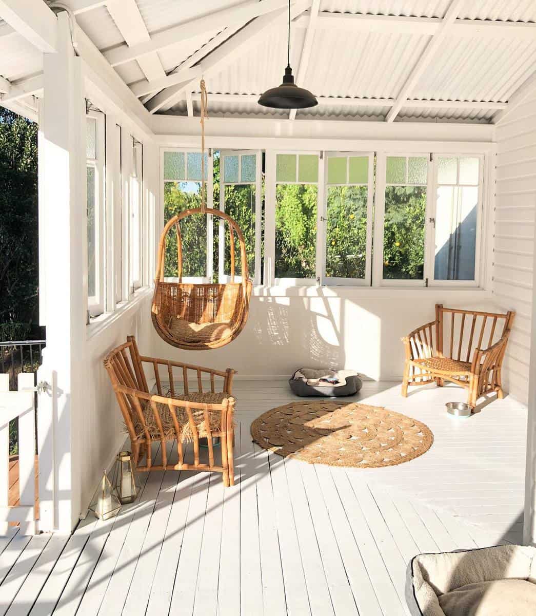 Simple fenced white patio wooden furniture in the backyard 